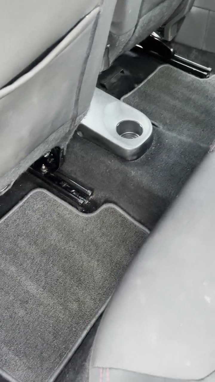 Clean rear floor mat and carpet in a Ford after vacuuming