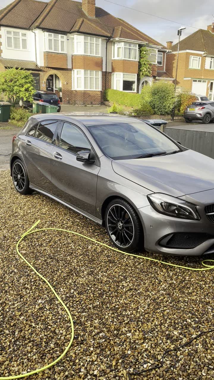 Silver Mercedes washed and gleaming on a gravel driveway